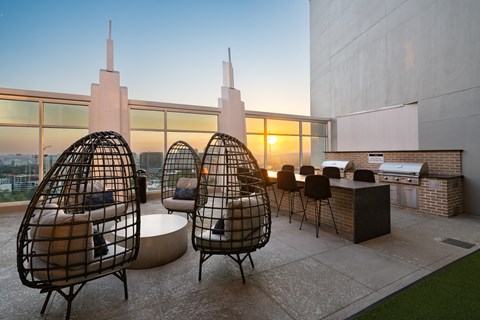 a living area with chairs and a table and a view of the city